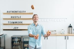 man juggles bagels during Nashville branding photography session
