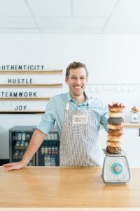 man stacks bagels on scale during Nashville branding photography session