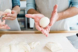 man rolls dough during branding portraits
