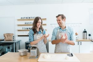 married couple creates bagels during branding photos