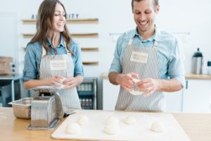 husband and wife team prepare bagels during Nashville branding photography session