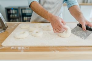 man creates bagels during Nashville branding photography session