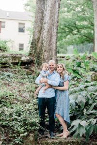 family of three poses in woods in West Nashville