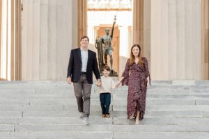 family walks down steps during War Memorial fall mini sessions