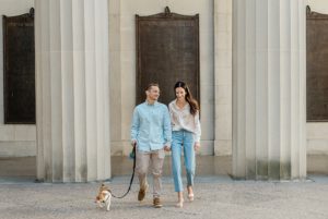 young couple walks with dog during family mini sessions