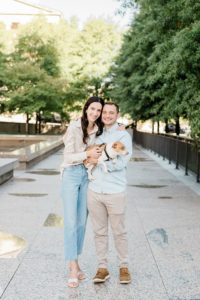 couple hugs with dog during War Memorial fall mini sessions in Nashville TN