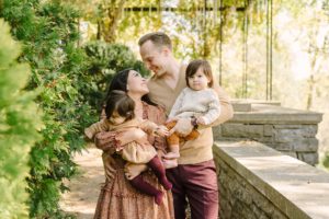 family of four smiles together during Cheekwood Estate family portraits