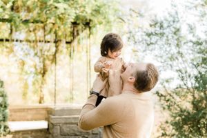 dad plays with daughter during Cheekwood Estate family portraits