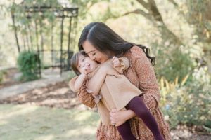 mom plays with daughter during Cheekwood Estate family portraits