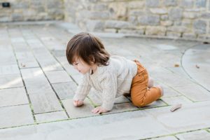 toddler crawls on stone patio at Cheekwood Estate & Gardens