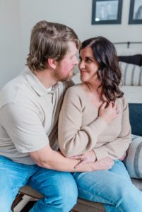 photographer and her husband sit on couch