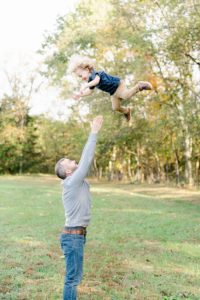 dad tosses son in the air during TN family portraits