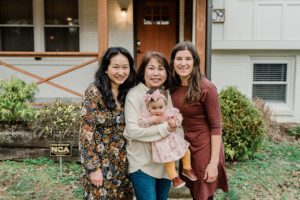 mom poses with two daughters and granddaughter