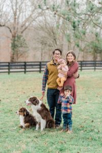 family with two children poses with two dogs during Nashville extended family portraits