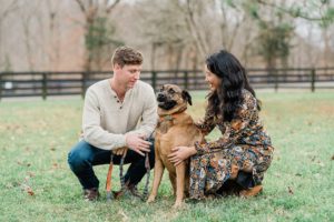 parents pose with dog during family photos in Nashville TN