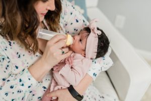 mom feeds baby during Nashville lifestyle newborn session