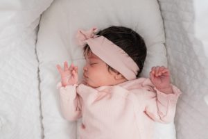 baby sleeps in basinet during newborn photos