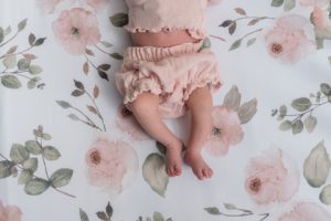 baby sleeps on floral sheets in crib during Nashville lifestyle newborn session