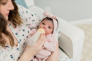 baby takes bottle during Nashville lifestyle newborn session