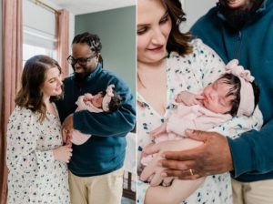 new parents smile at daughter during photos at home