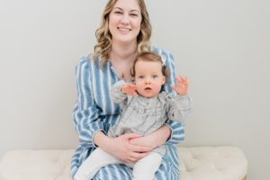 mom holds daughter during Nashville studio family portraits