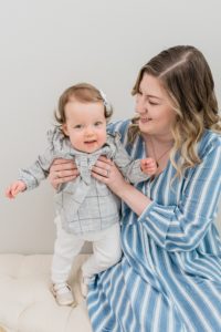 mom holds up one year old during Nashville studio family portraits