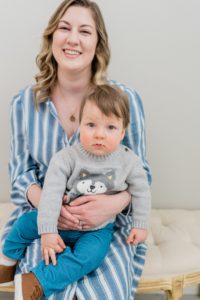 mom holds son during family photos in studio