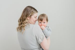 mom holds son looking at him during Nashville studio family portraits