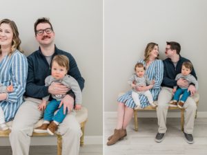 parents smile at each other holding twins during Nashville studio family portraits