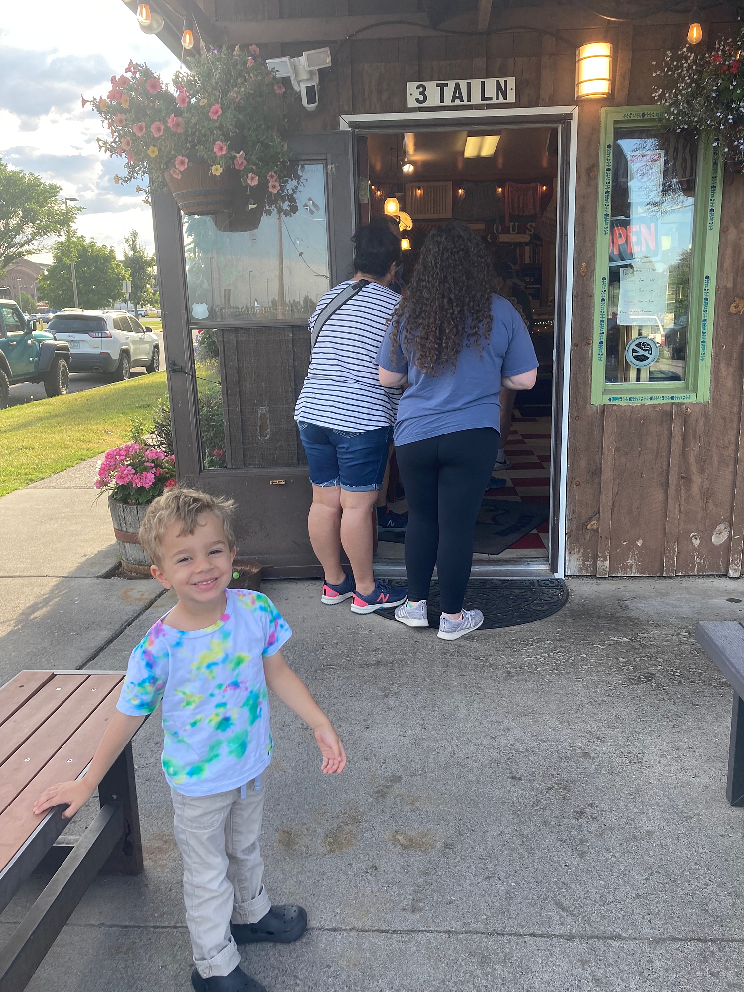 toddler_standing_in_front_of_Grannys_donut_shop_in_bozeman_montana