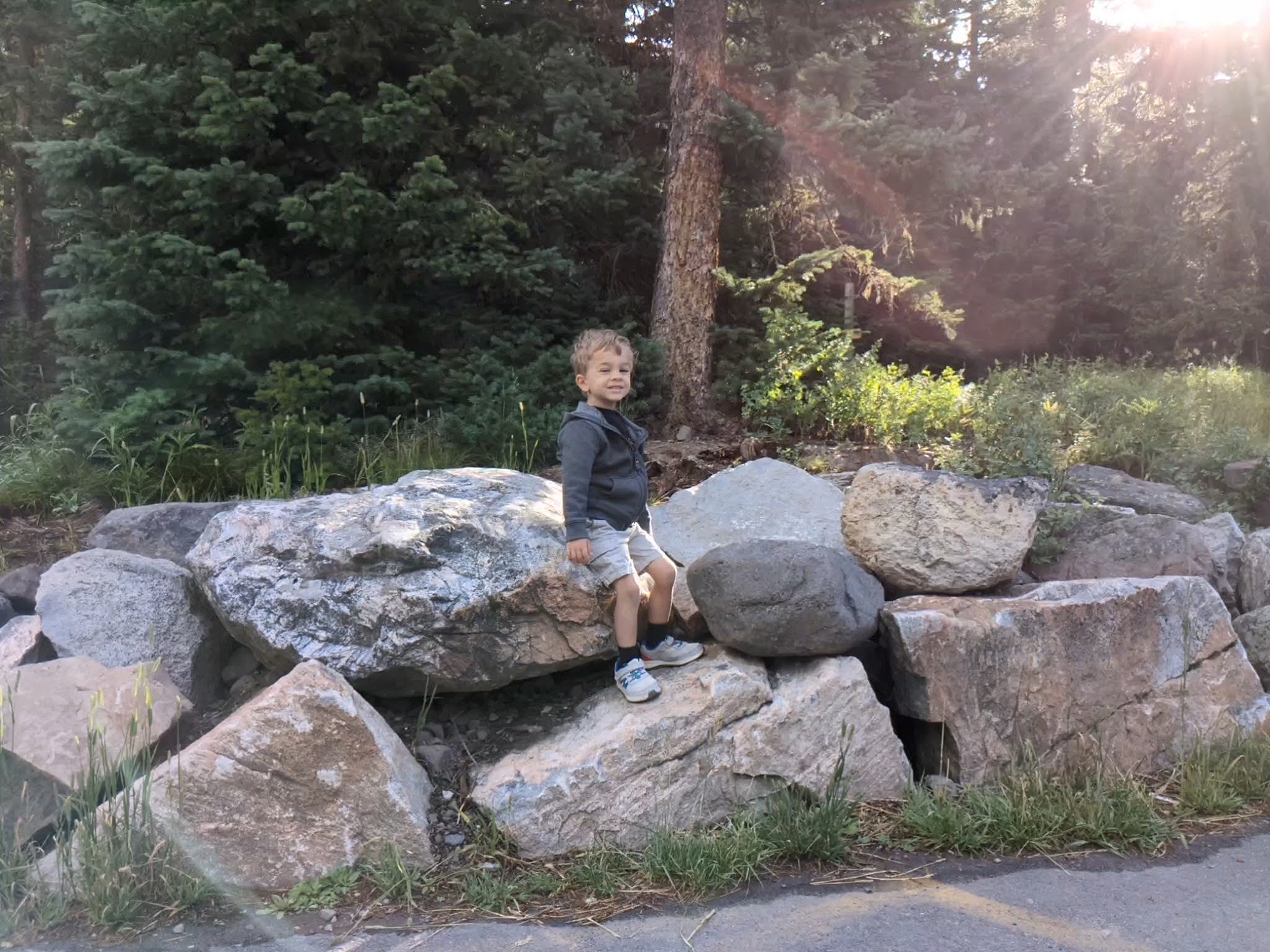 toddler_smiling_while_sitting_on_rocks_at_palisade_trail