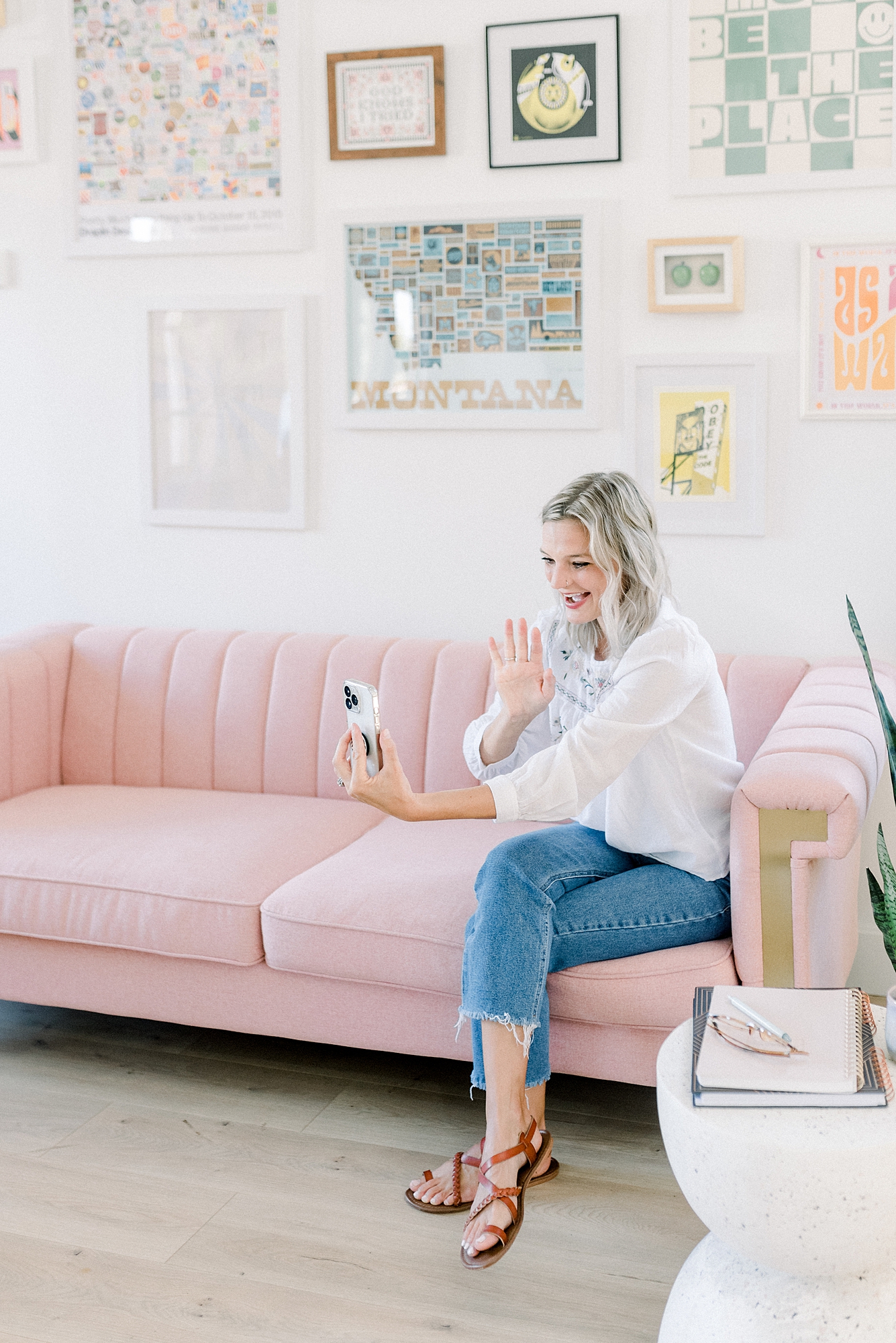a_woman_sitting_on_pink_couch_holding_a_cup_of_coffee_for_her_branding_session_by_Dolly_DeLong_Photography_in_Bozeman_Montana