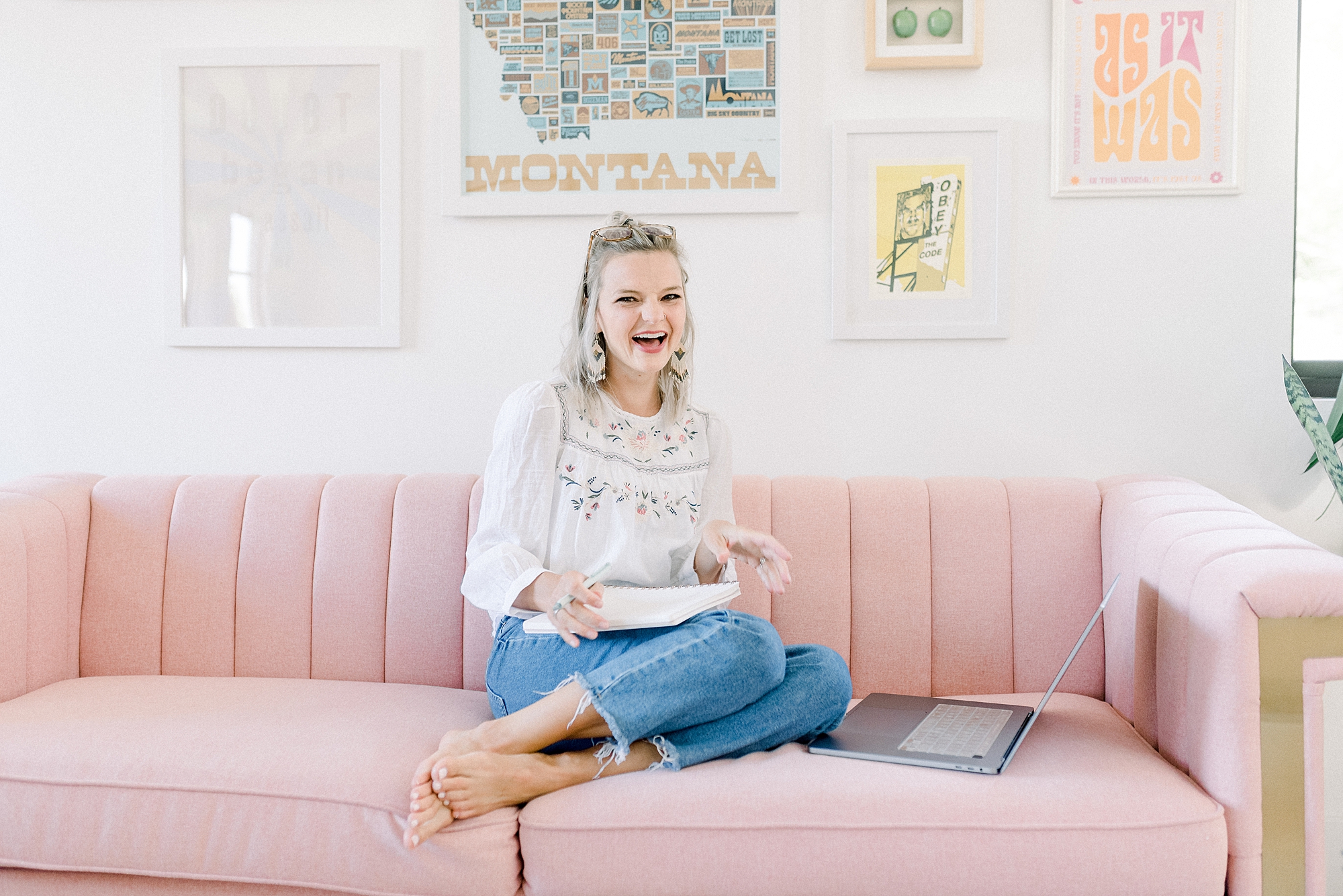 a_woman_is_sitting_on_a_pink_couch_for_her_branding_photo_session_at_cheers_haus_in_Bozeman_Montana_by_Branding_Photographer_Dolly_DeLong