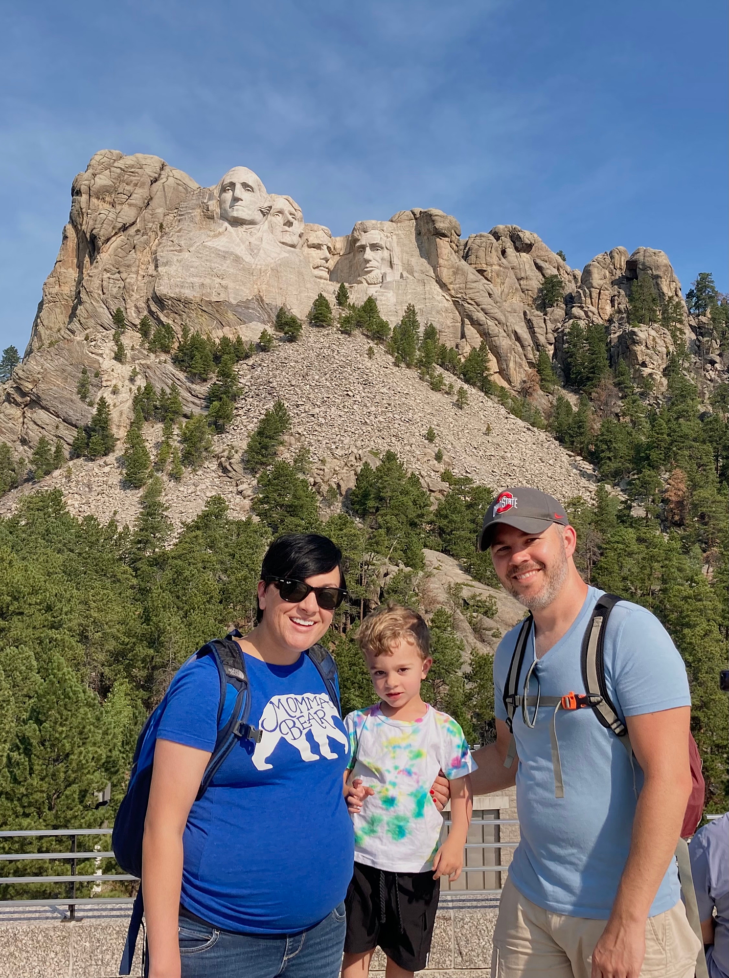 family_of_three_standing_in_front_of_mount_rushmore