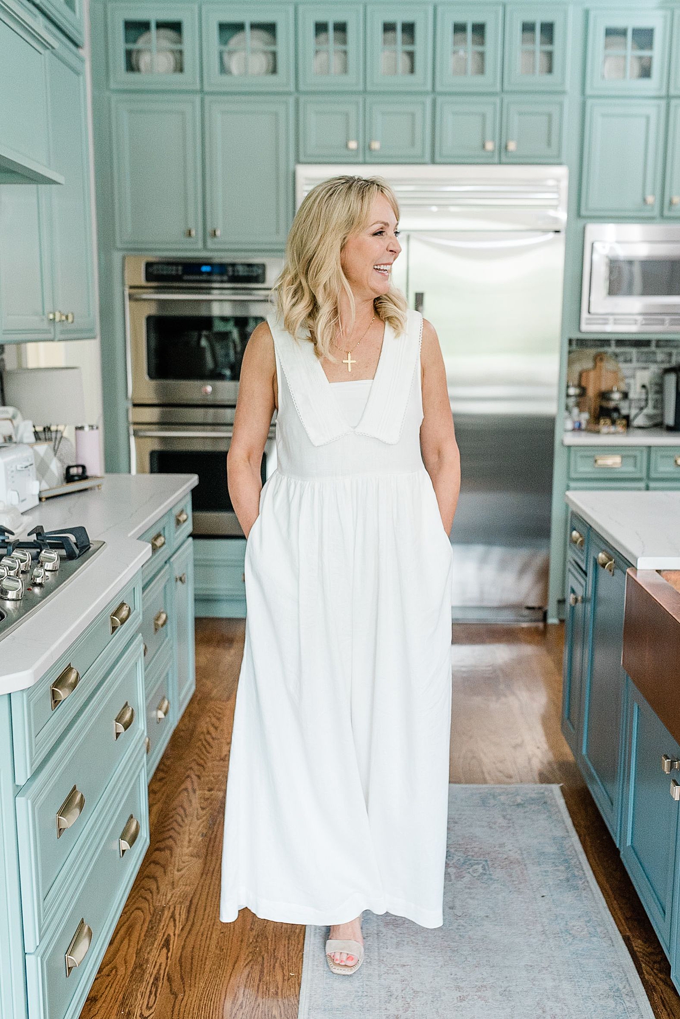 a_middle_aged_woman_is_taking_her_Nashville_branding_photos_for_her_real_estate_business_standing_in_a_big_kitchen