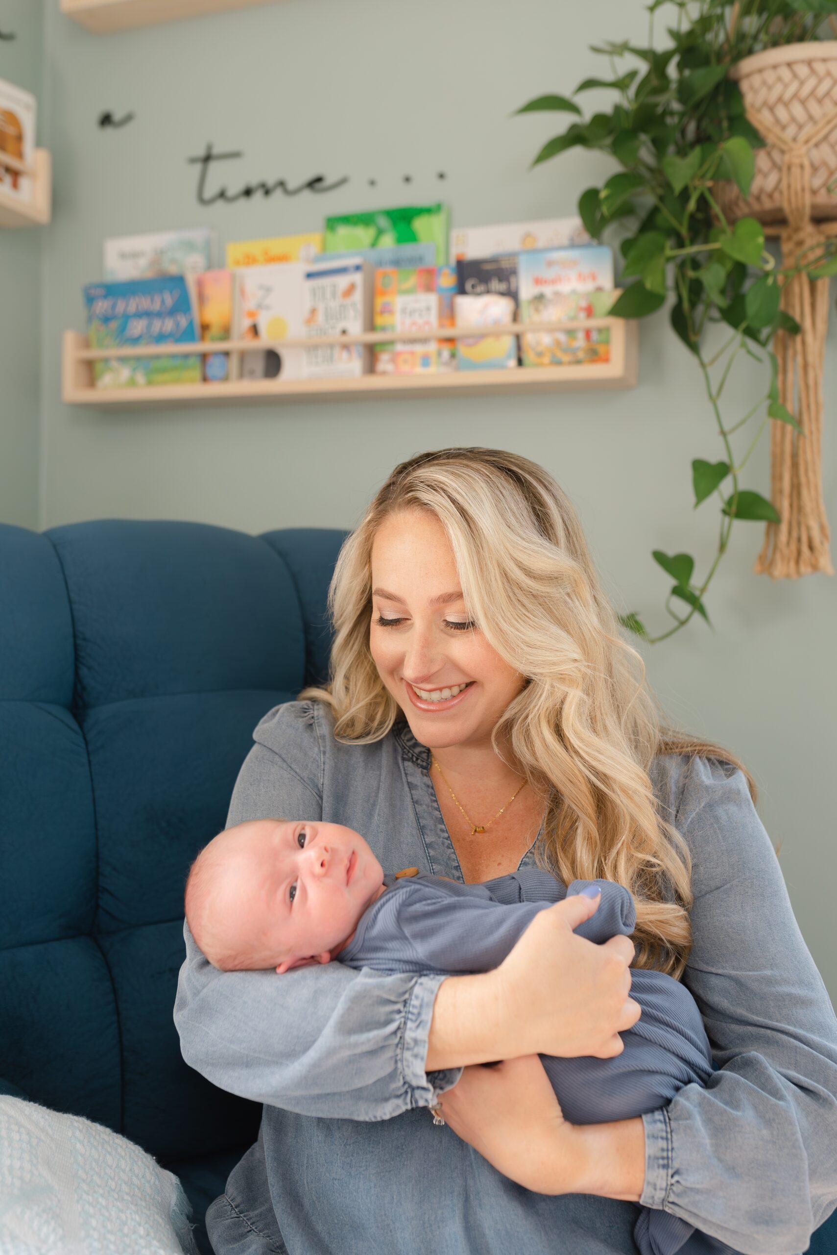 a_mom_holding_her_newborn_son_for_his_nashville_newborn_session_with_Dolly_DeLong_Photography
