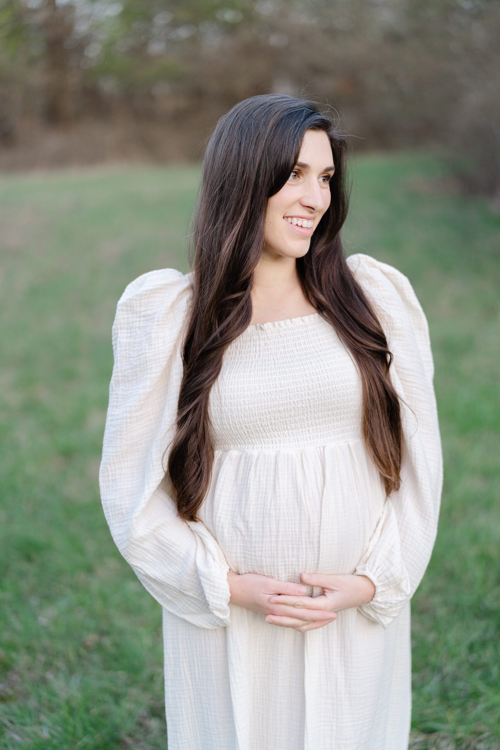 a_pregnant_mom_is_wearing_a_white_nothing_fits_but_maternity_dress_for_her_Maternity_session_in_nashville_with_Nashville_family_photographer_Dolly_DeLong_Photography_spring_maternity_session