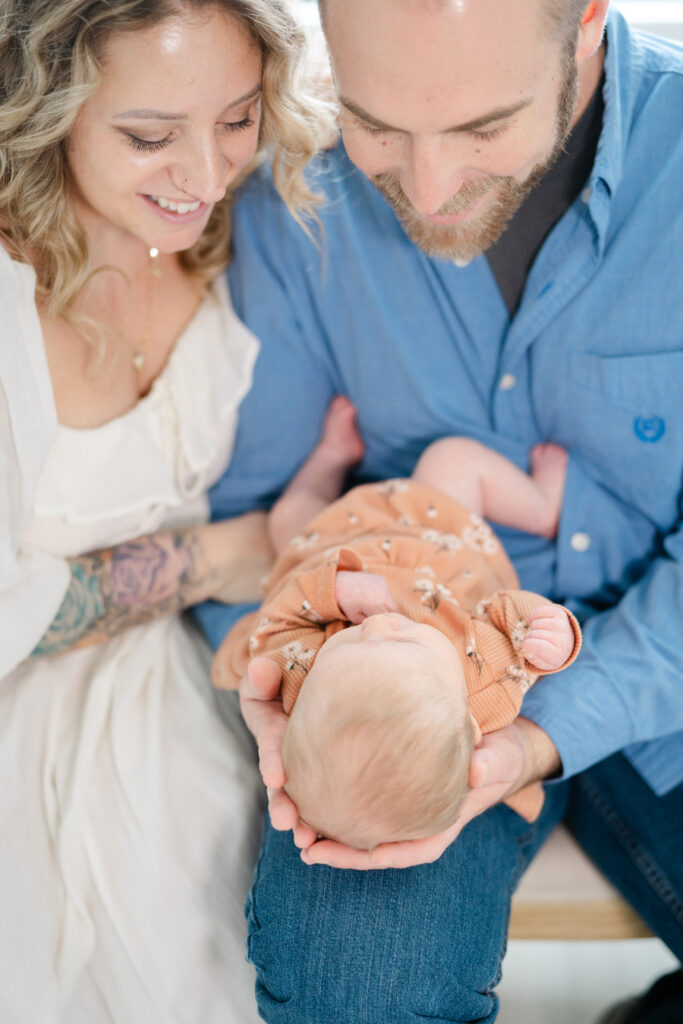 Mom and dad looking down at newborn baby
