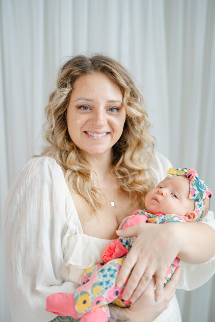 Mom smiling and holding baby