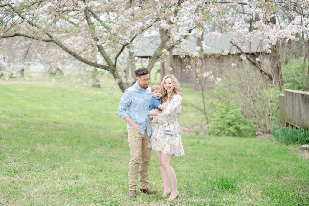 Couple posing with their child in Nashville