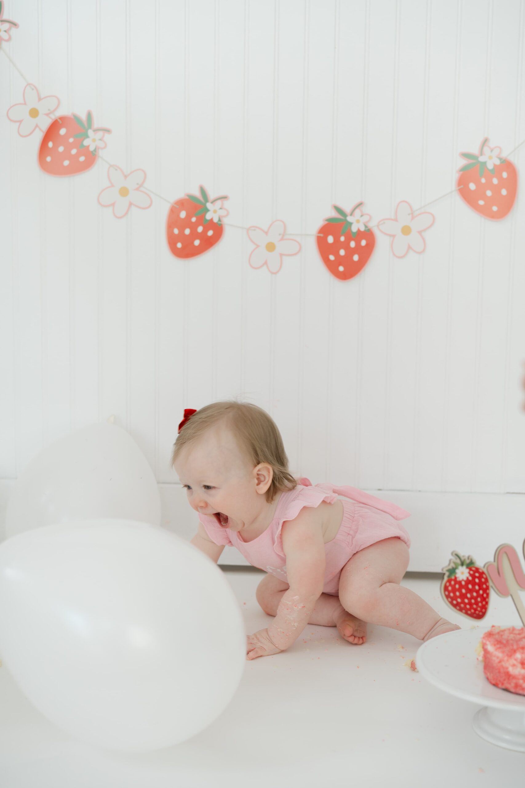 smiling-baby-girl-crawling-on-the-floor-during-a-cakesmash-session-in-franklin-tennessee