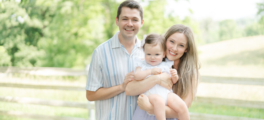 Family of three posing together during light-filled Ellington Agricultural Center photos in Nashville.