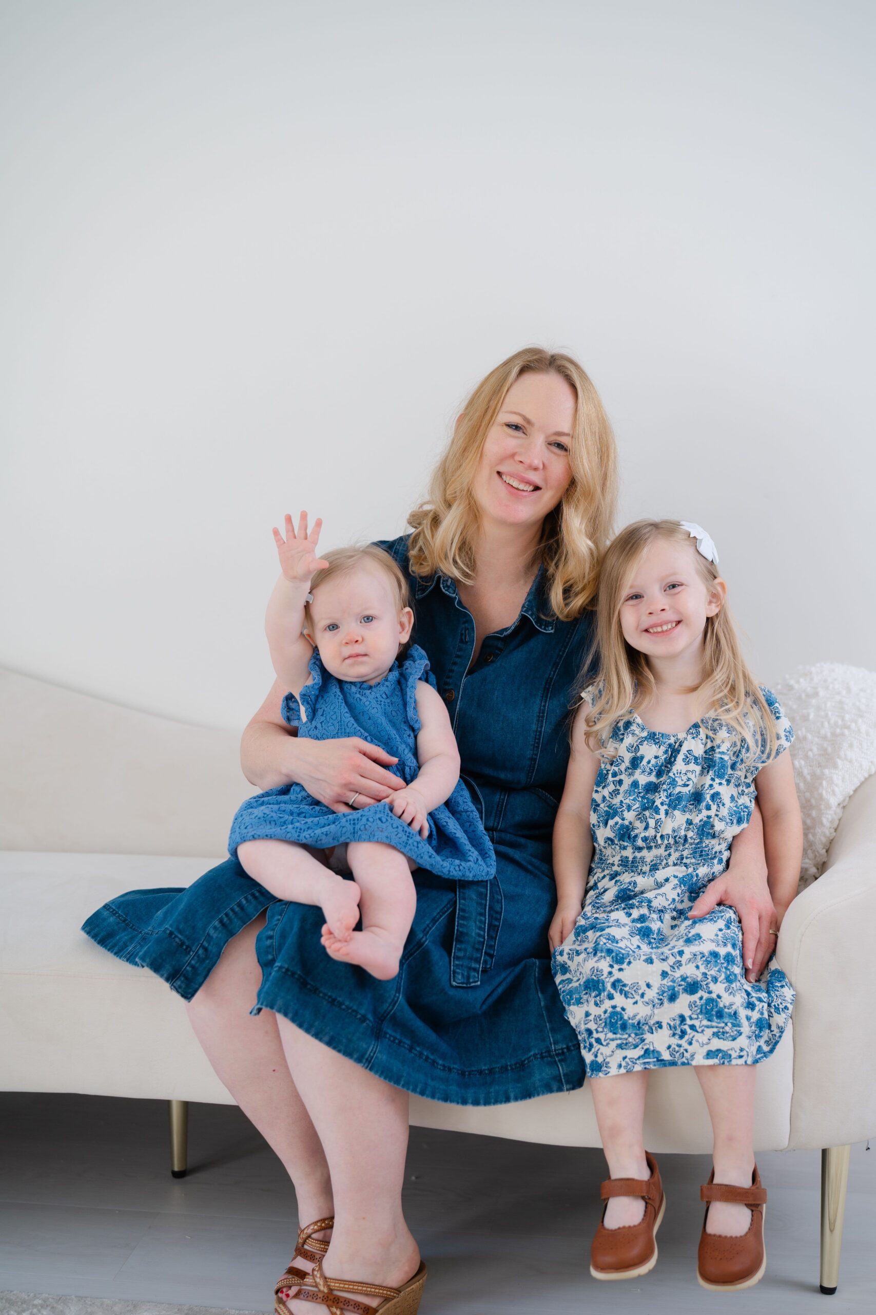 Mother with two daughters on a couch during a Mother’s Day motherhood portrait session in Franklin TN.