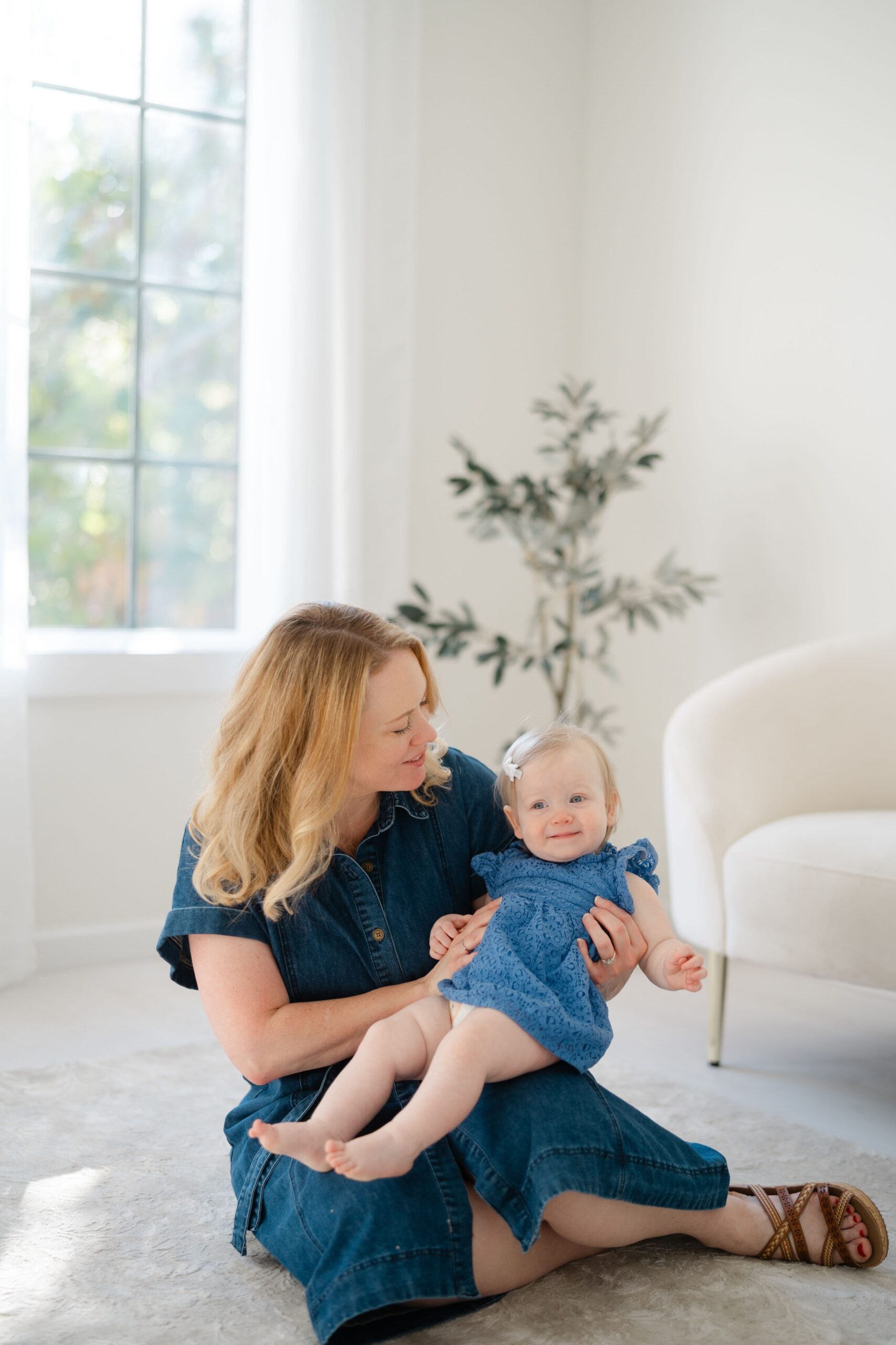 Mother holding her baby during a Mother’s Day motherhood portrait mini session in Franklin TN studio.