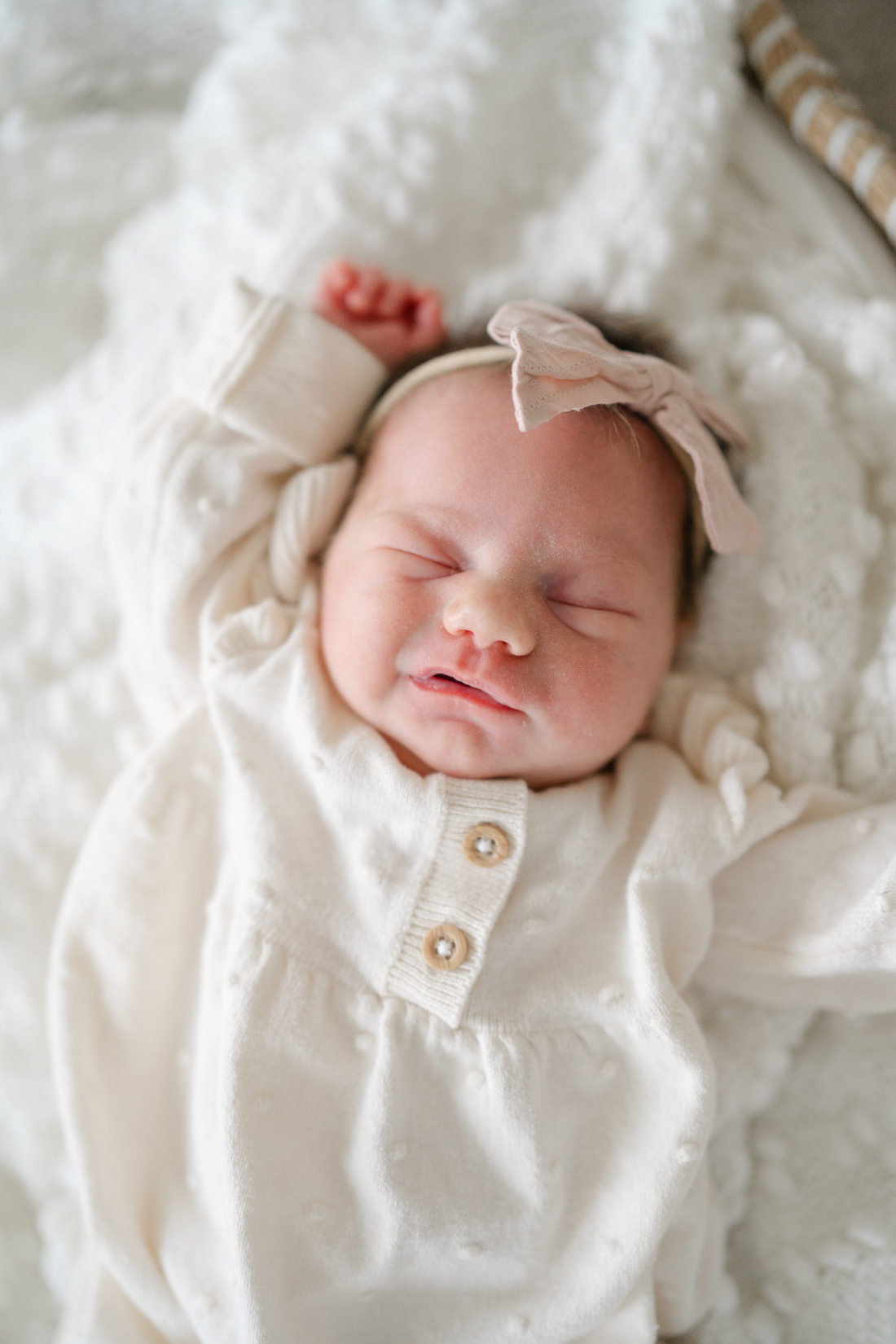 Soft lifestyle newborn photo session image of baby laying on a cozy blanket