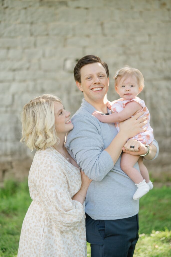 Parents and their baby girl during a spring family photo session at Ravenswood Mansion in Nashville TN