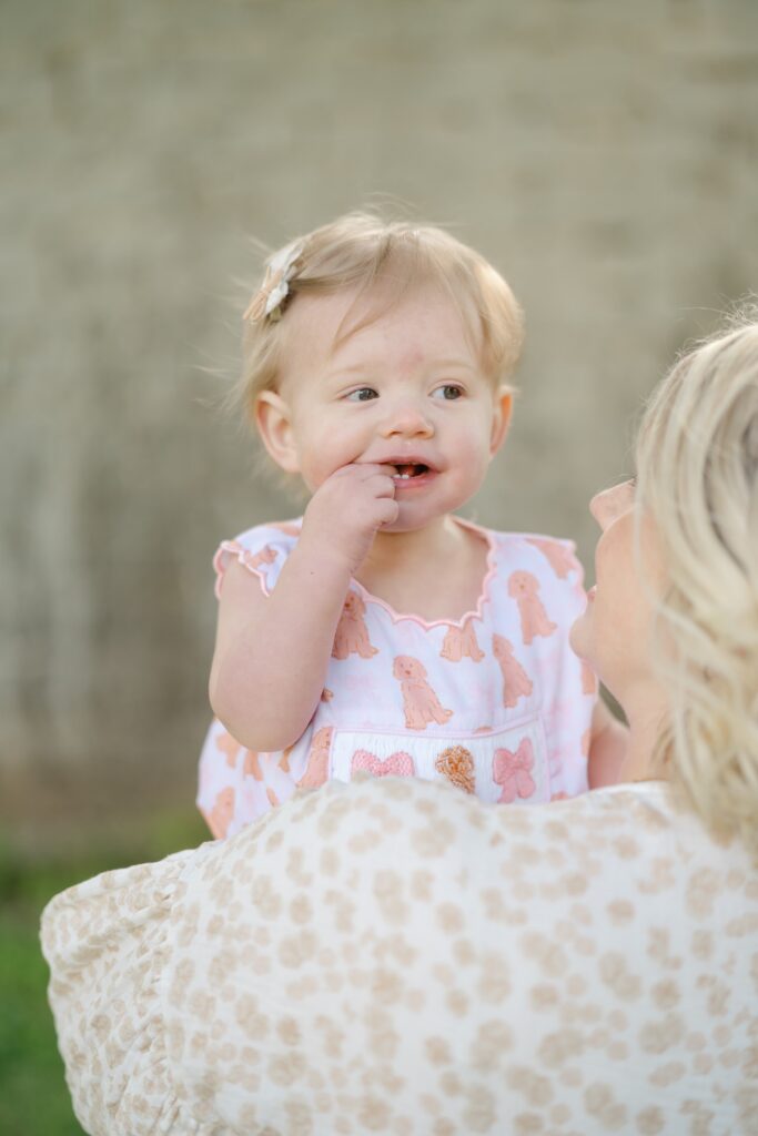 Close up of a smiling one year old during her birthday portrait session at Ravenswood Mansion