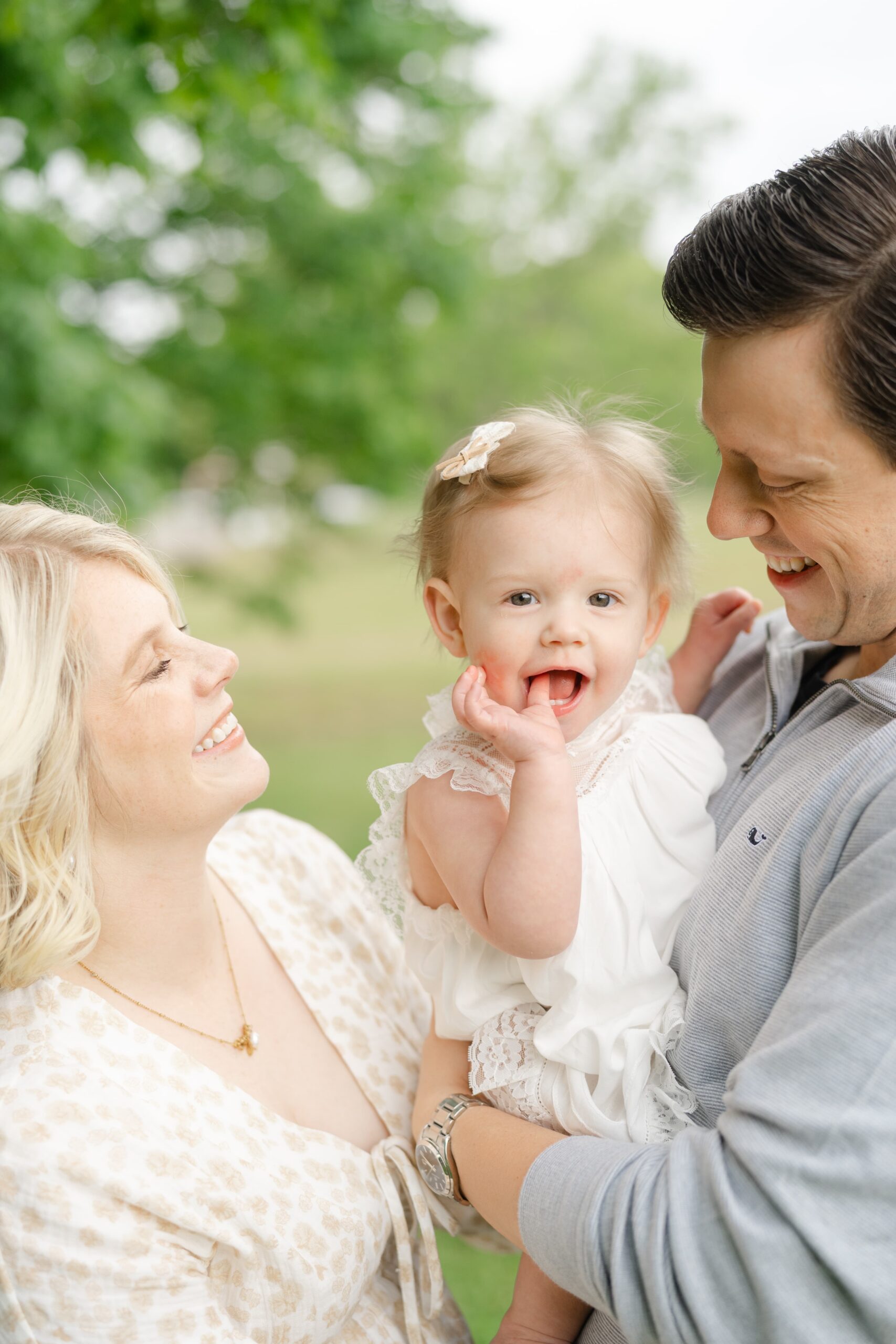 Close up of a baby girl laughing with her parents at Ravenswood Mansion in Nashville TN