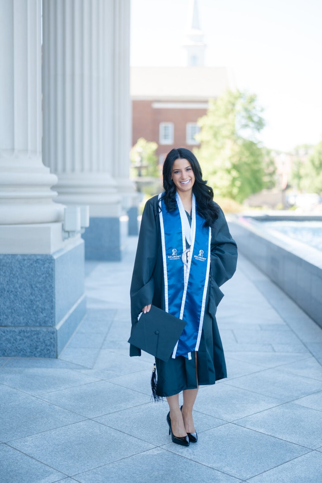 College graduation photos at Belmont University Nashville with graduate in black gown and blue Belmont stole