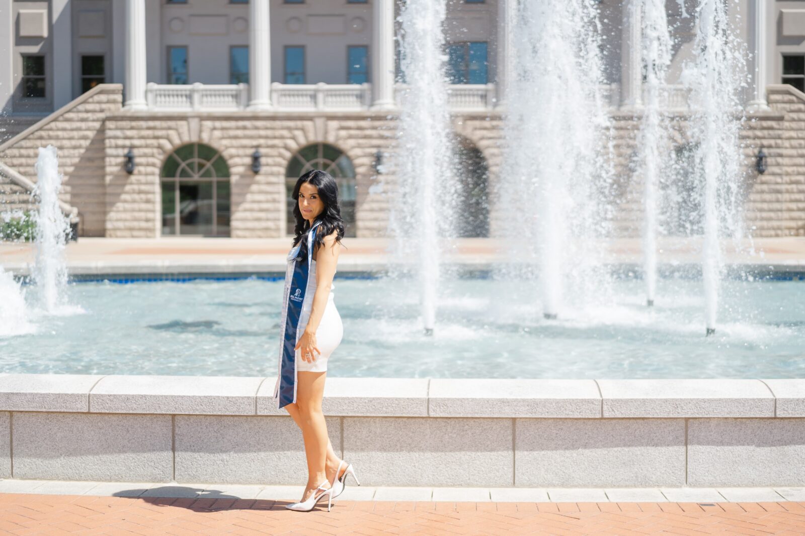 Belmont University graduation portrait with a grad posed in front of the campus fountain in Nashville TN